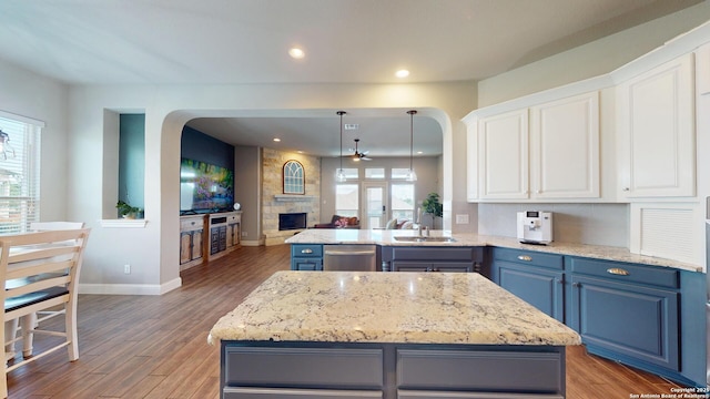 2542 Varrelmann, New Braunfels, TX 78132 - kitchen featuring dishwasher, blue cabinets, baseboards, arched walkways, and recessed lighting