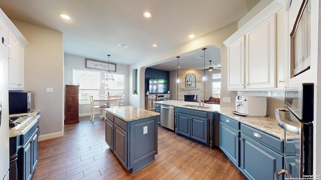 2542 Varrelmann, New Braunfels, TX 78132 - kitchen featuring blue cabinets, a sink, appliances with stainless steel finishes, white cabinetry, and recessed lighting