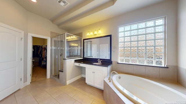 2542 Varrelmann, New Braunfels, TX 78132 - bathroom featuring a stall shower, a garden tub, vanity, tile patterned flooring, and a walk in closet