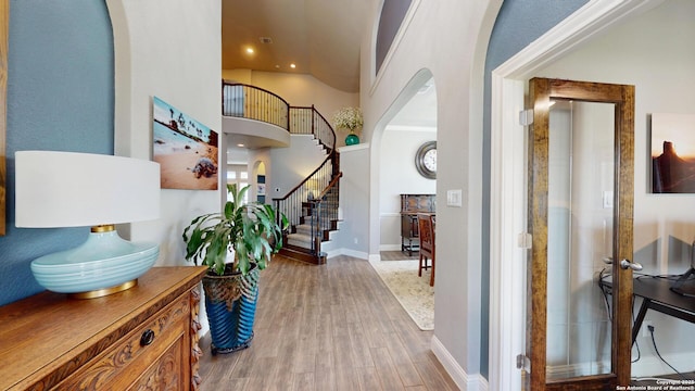 2542 Varrelmann, New Braunfels, TX 78132 - foyer entrance featuring arched walkways, wood finished floors, baseboards, lofted ceiling, and recessed lighting