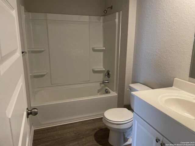 1138 Gracie Way, New Braunfels, TX 78130 - full bathroom with a textured wall, toilet, vanity, wood finished floors, and shower / tub combination