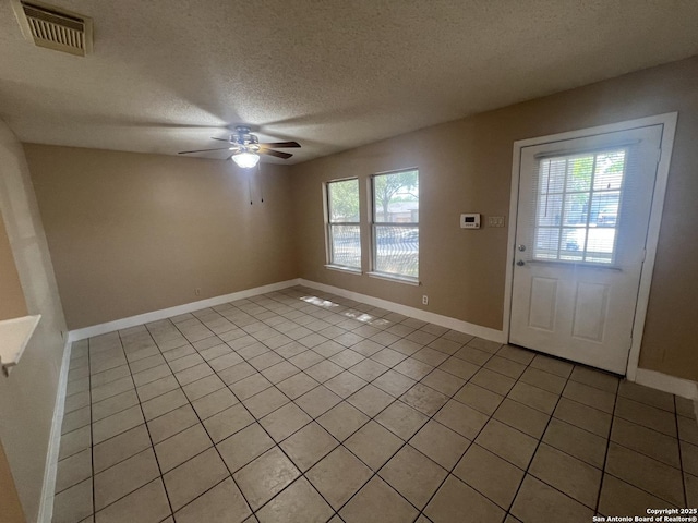15558 Knollmeadow, San Antonio, TX 78247 - entrance foyer with light tile patterned floors, ceiling fan, a textured ceiling, and baseboards