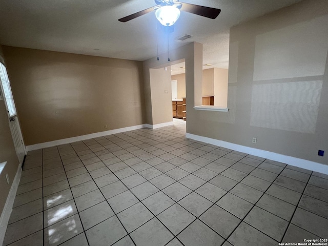 15558 Knollmeadow, San Antonio, TX 78247 - spare room with light tile patterned floors, ceiling fan, and baseboards