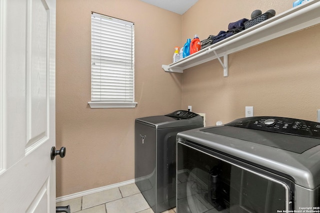 8807 Brae Crst, San Antonio, TX 78249 - laundry area with washer and dryer, baseboards, and light tile patterned flooring
