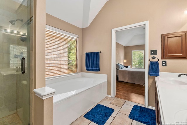 8807 Brae Crst, San Antonio, TX 78249 - full bathroom featuring vaulted ceiling, a stall shower, plenty of natural light, and connected bathroom