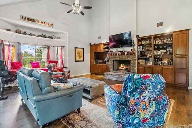 111 Kendall Oaks, Boerne, TX 78006 - living area featuring a towering ceiling, wood finished floors, ceiling fan, a fireplace, and baseboards
