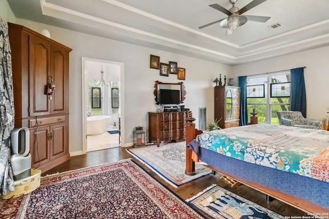 111 Kendall Oaks, Boerne, TX 78006 - bedroom with a raised ceiling, multiple windows, wood finished floors, and connected bathroom