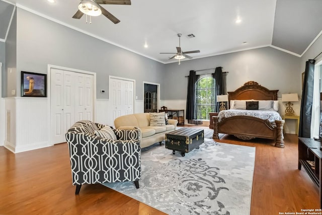 111 Kendall Oaks, Boerne, TX 78006 - bedroom featuring wood finished floors, multiple closets, wainscoting, crown molding, and lofted ceiling