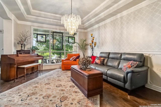 111 Kendall Oaks, Boerne, TX 78006 - living room with a tray ceiling, wood finished floors, a chandelier, and ornamental molding