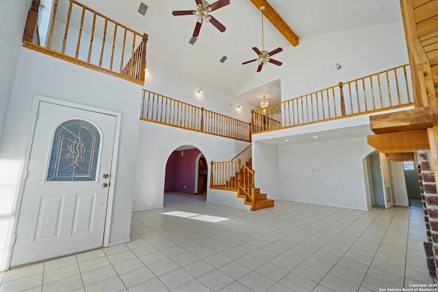 714 N Carroll, Poth, TX 78147 - tiled foyer entrance with arched walkways, a ceiling fan, high vaulted ceiling, stairs, and beamed ceiling