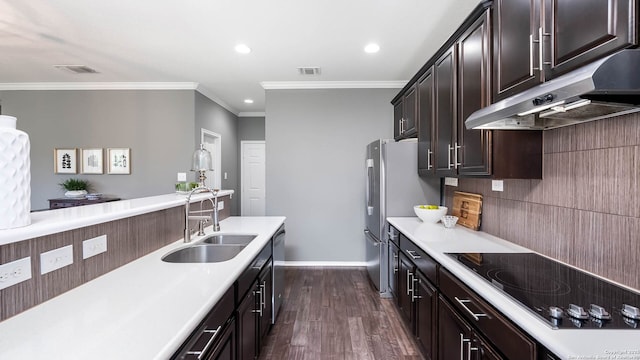 2527 Villa Rufina, San Antonio, TX 78259 - kitchen featuring under cabinet range hood, a sink, appliances with stainless steel finishes, crown molding, and dark wood finished floors