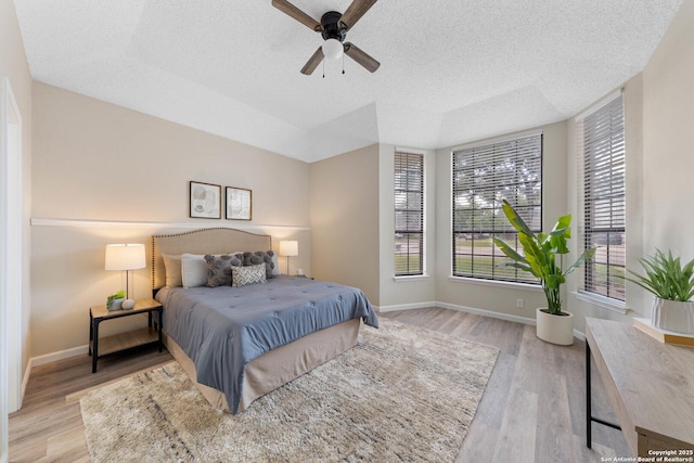 11302 Cedar Park, San Antonio, TX 78249 - bedroom with wood finished floors, a textured ceiling, baseboards, and a ceiling fan