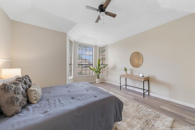 11302 Cedar Park, San Antonio, TX 78249 - bedroom with baseboards, a textured ceiling, wood finished floors, and a ceiling fan