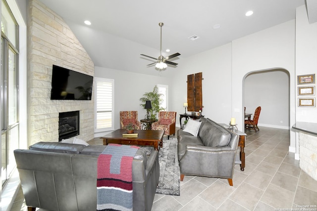 23018 Osprey, San Antonio, TX 78260 - living area featuring lofted ceiling, a fireplace, ceiling fan, light tile patterned flooring, and arched walkways