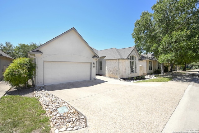 23018 Osprey, San Antonio, TX 78260 - view of front of property with driveway, a garage, and stucco siding