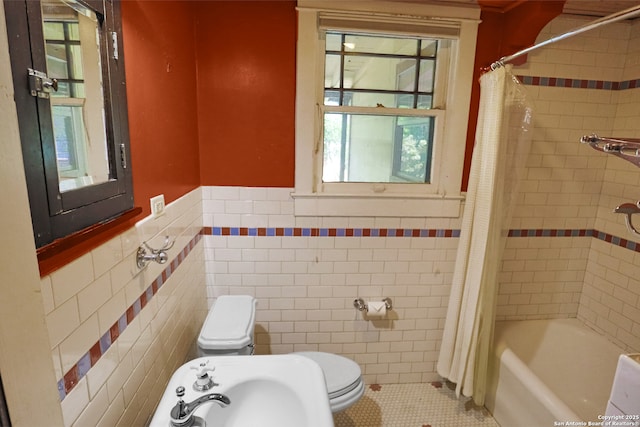 1919 W Magnolia Ave, San Antonio, TX 78201 - bathroom featuring tile walls, wainscoting, a sink, tile patterned flooring, and toilet