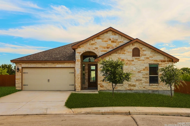 4862 Blue Jasmin, San Antonio, TX 78245 - french country style house featuring an attached garage, driveway, stone siding, and fence
