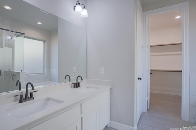 4862 Blue Jasmin, San Antonio, TX 78245 - full bath with a shower stall, recessed lighting, a spacious closet, double vanity, and baseboards