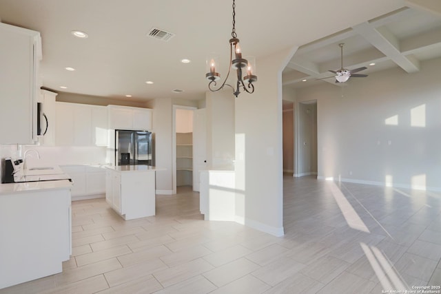 4862 Blue Jasmin, San Antonio, TX 78245 - kitchen featuring stainless steel fridge, open floor plan, ceiling fan, beamed ceiling, and coffered ceiling