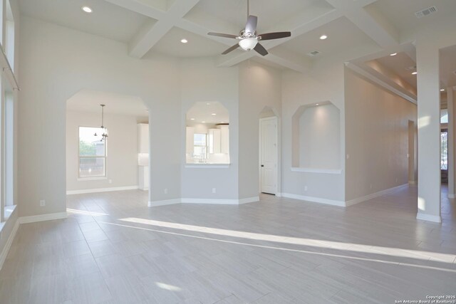 4862 Blue Jasmin, San Antonio, TX 78245 - unfurnished living room with arched walkways, coffered ceiling, ceiling fan, recessed lighting, and beamed ceiling