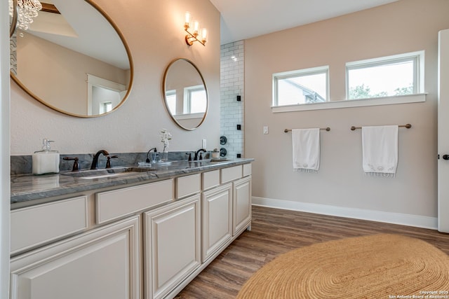 2191 Grandview Frst, Canyon Lake, TX 78133 - bathroom featuring wood finished floors, double vanity, and baseboards