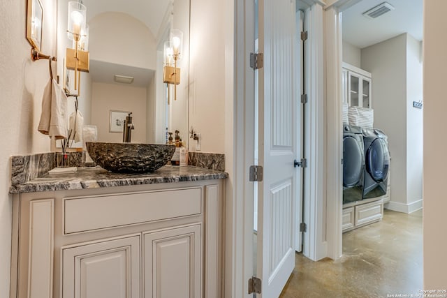 2191 Grandview Frst, Canyon Lake, TX 78133 - bathroom with washer and dryer, concrete floors, vanity, and baseboards