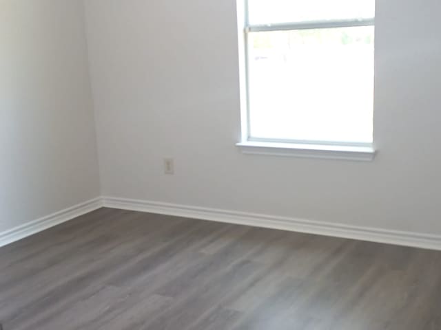 8610 James, Somerset, TX 78069 - empty room featuring baseboards and dark wood-type flooring