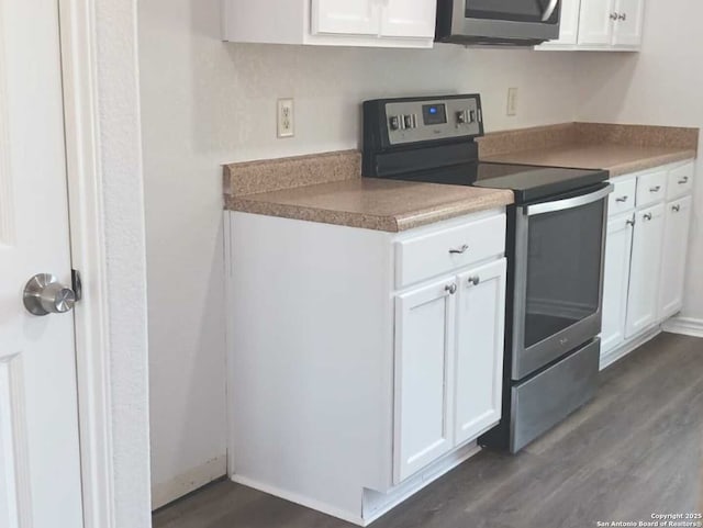 8610 James, Somerset, TX 78069 - kitchen with stainless steel appliances, dark wood-type flooring, and white cabinets