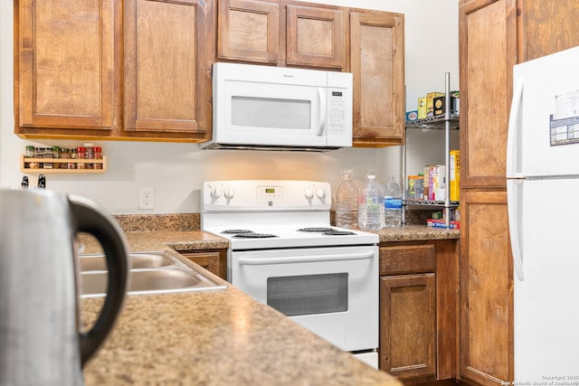 17 Oak Plz, San Antonio, TX 78216 - kitchen with white appliances, light countertops, and brown cabinetry