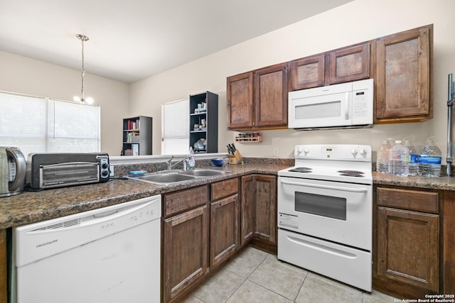 17 Oak Plz, San Antonio, TX 78216 - kitchen featuring white appliances, a sink, light tile patterned floors, dark countertops, and a peninsula