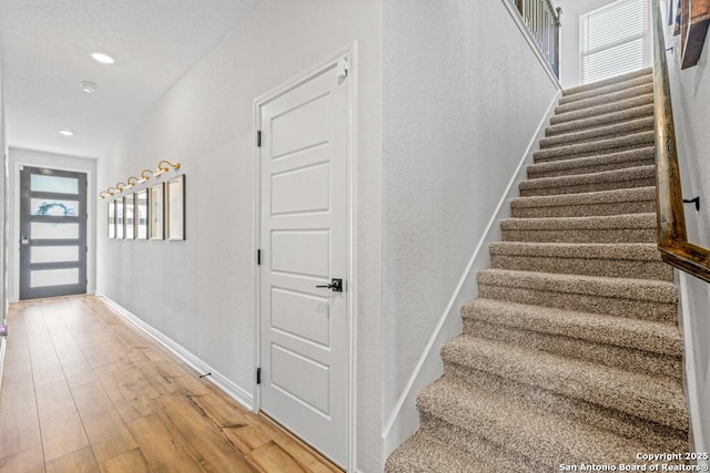 25826 Marigold Oaks, Boerne, TX 78006 - stairway with baseboards, wood finished floors, and recessed lighting