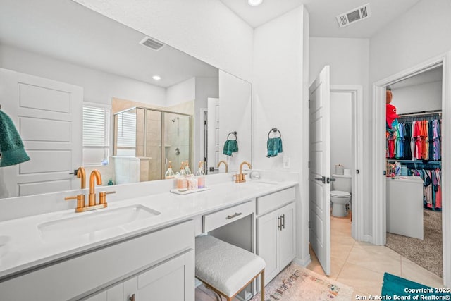25826 Marigold Oaks, Boerne, TX 78006 - full bathroom with a shower stall, double vanity, toilet, tile patterned floors, and recessed lighting