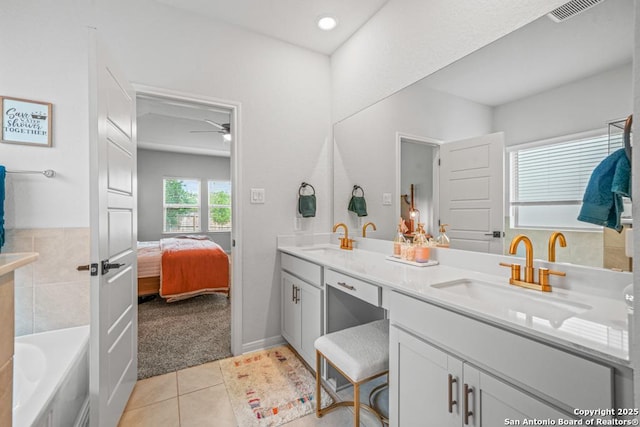 25826 Marigold Oaks, Boerne, TX 78006 - bathroom featuring tile patterned floors, double vanity, connected bathroom, ceiling fan, and a tub to relax in