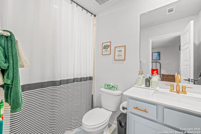 25826 Marigold Oaks, Boerne, TX 78006 - bathroom featuring toilet, vanity, a textured wall, and curtained shower