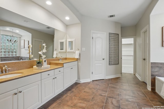 51 Stonewall Bnd, San Antonio, TX 78256 - bathroom with tile patterned flooring, recessed lighting, double vanity, and a spacious closet