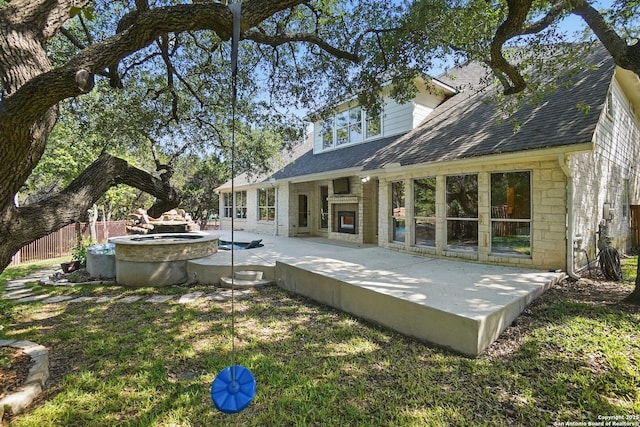 51 Stonewall Bnd, San Antonio, TX 78256 - rear view of house featuring a patio area, fence, a shingled roof, and stone siding