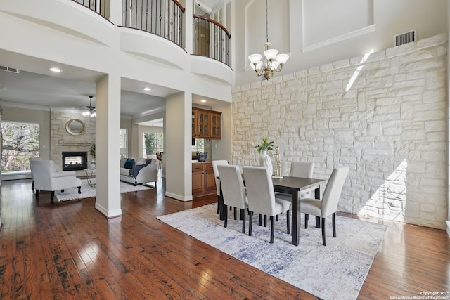 51 Stonewall Bnd, San Antonio, TX 78256 - dining area featuring plenty of natural light, dark wood-type flooring, a chandelier, ornamental molding, and a ceiling fan