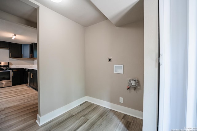312 Avondale, San Antonio, TX 78223 - washroom with electric dryer hookup, light wood-style flooring, baseboards, and hookup for a washing machine