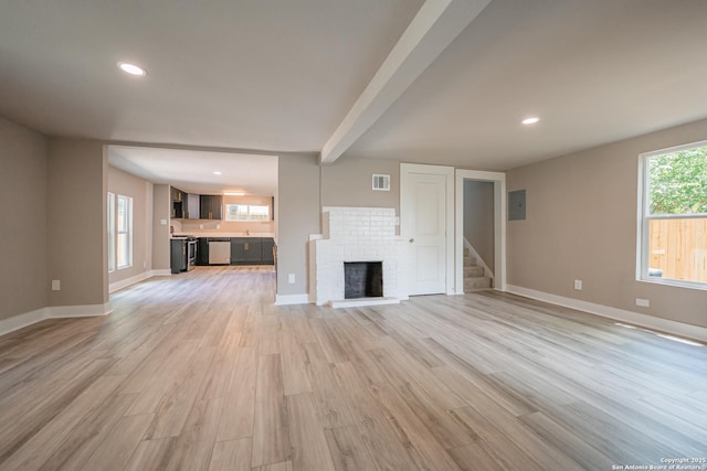 312 Avondale, San Antonio, TX 78223 - unfurnished living room featuring a brick fireplace, light wood-style floors, stairway, baseboards, and recessed lighting