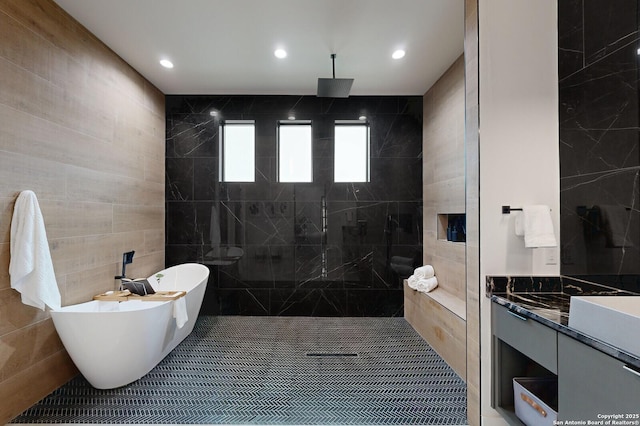 1356 Capitare, New Braunfels, TX 78132 - bathroom featuring tile walls, a tile shower, a freestanding tub, vanity, and recessed lighting