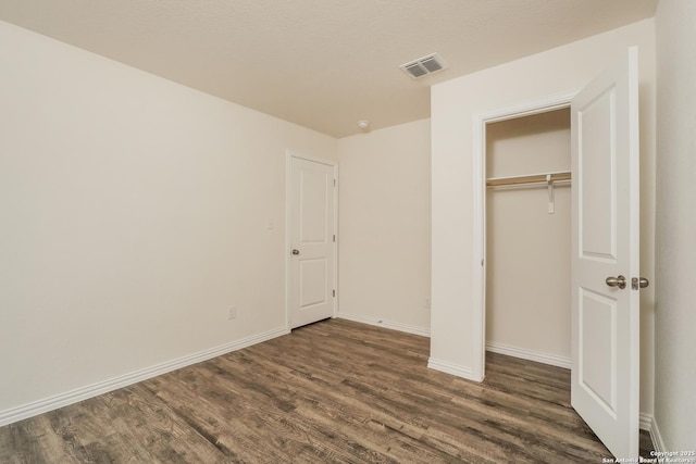 237 Corliss, San Antonio, TX 78220 - unfurnished bedroom featuring wood finished floors, baseboards, and a closet