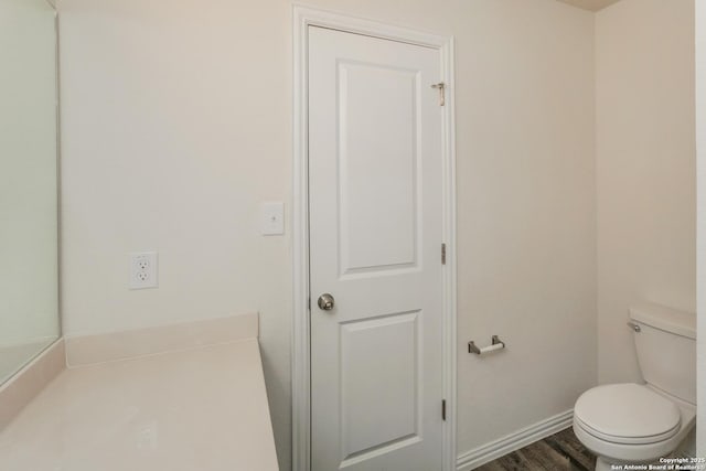 237 Corliss, San Antonio, TX 78220 - bathroom with toilet, baseboards, and wood finished floors