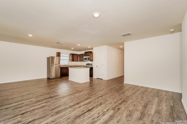 237 Corliss, San Antonio, TX 78220 - unfurnished living room with wood finished floors, recessed lighting, and baseboards