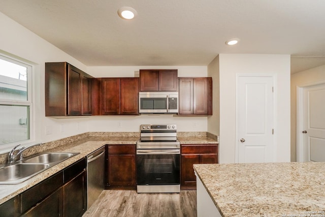 237 Corliss, San Antonio, TX 78220 - kitchen featuring appliances with stainless steel finishes, a sink, light wood-style flooring, and recessed lighting