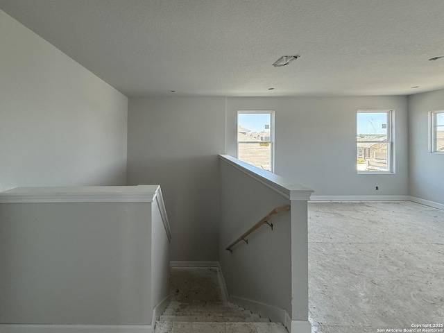 14724 Sycamore Xing, San Antonio, TX 78252 - staircase featuring baseboards, plenty of natural light, and a textured ceiling