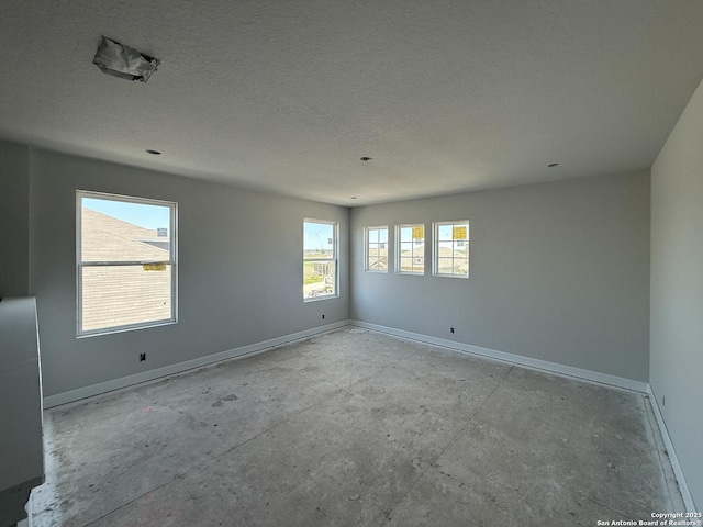 14724 Sycamore Xing, San Antonio, TX 78252 - spare room with baseboards and a textured ceiling