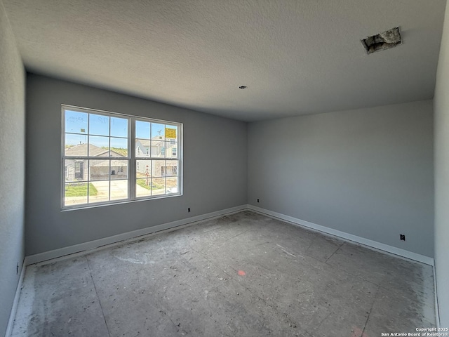 14724 Sycamore Xing, San Antonio, TX 78252 - empty room featuring baseboards and a textured ceiling