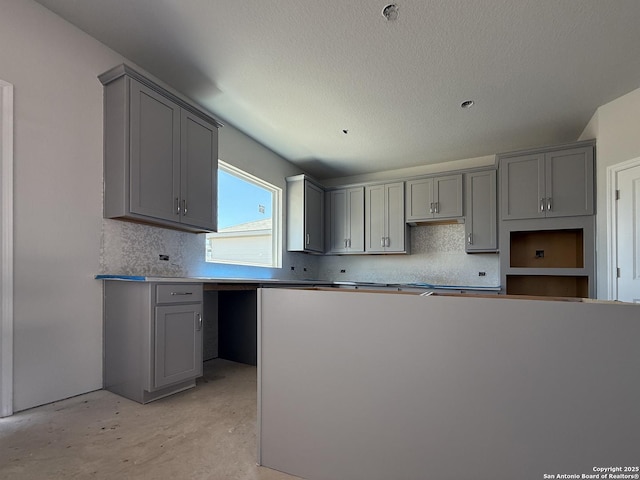 14724 Sycamore Xing, San Antonio, TX 78252 - kitchen with gray cabinets, backsplash, and concrete floors