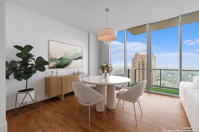 610 E Market St Unit 3110, San Antonio, TX 78205 - dining room with wood finished floors, a view of city, and expansive windows