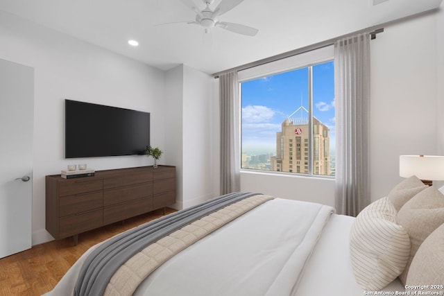 610 E Market St Unit 3110, San Antonio, TX 78205 - bedroom with wood finished floors, recessed lighting, and a ceiling fan